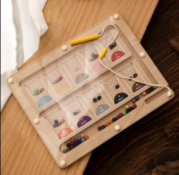 A wooden tray with many different colored beads.