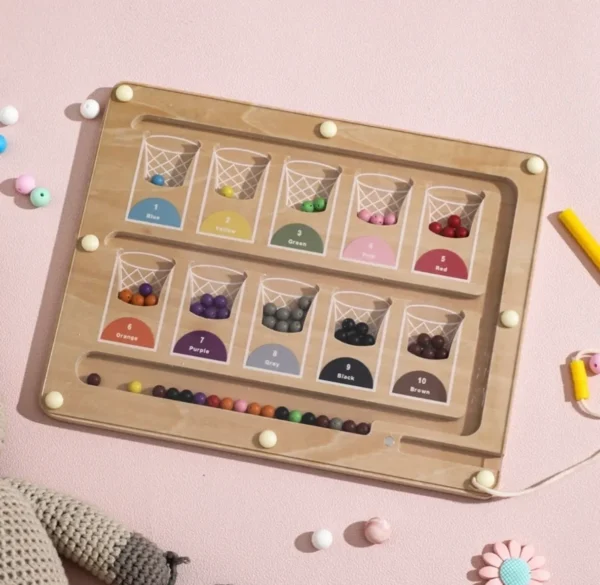 A wooden tray with many different colored beads.