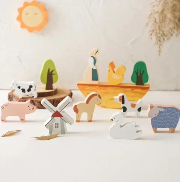 A group of wooden animals sitting on top of a table.