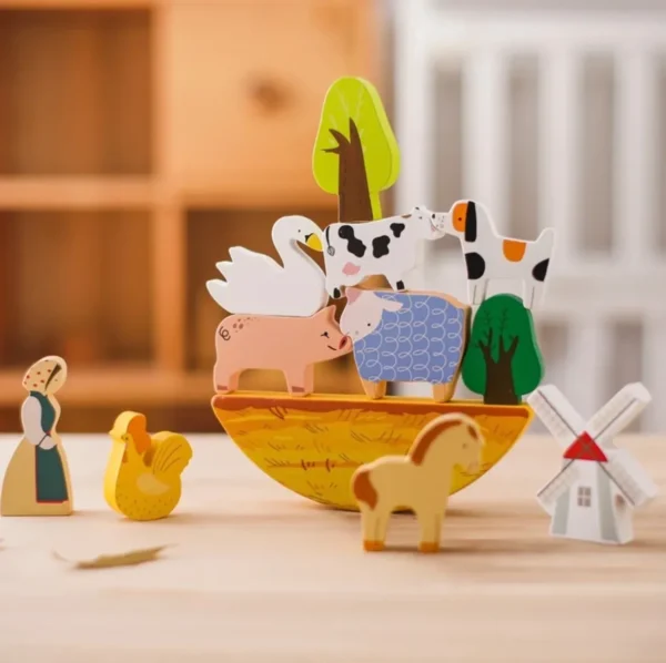 A wooden toy boat with animals on it.