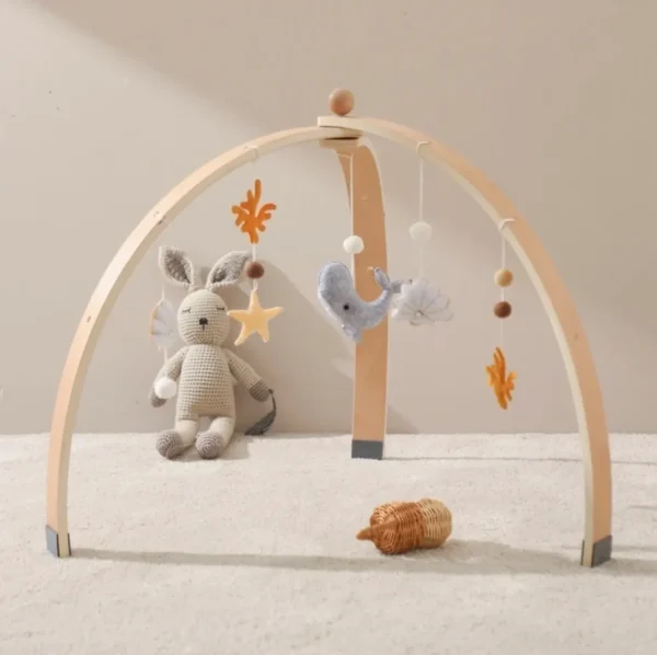 A baby crib with toys and a stuffed animal.