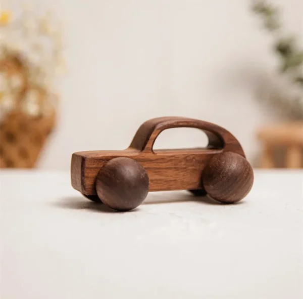 A wooden toy car is sitting on the table.