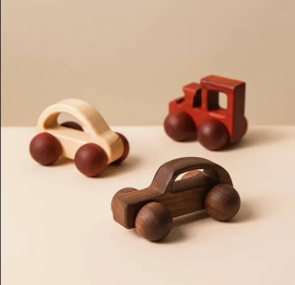 A group of wooden toy cars on top of a table.