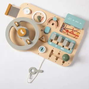 A wooden toy steering wheel with various objects.