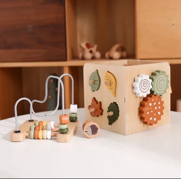 A wooden block with magnets and other items on it.