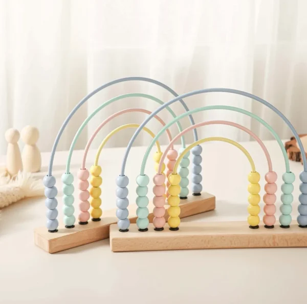 A set of four wooden abacus toys on top of a table.