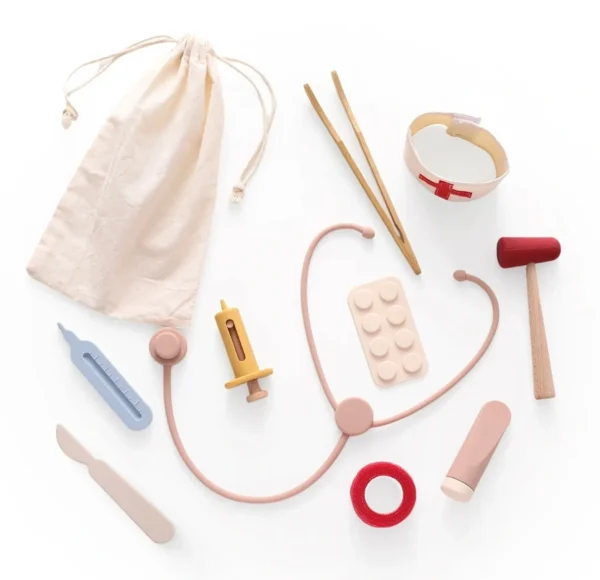 A wooden toy set of medical equipment and tools.