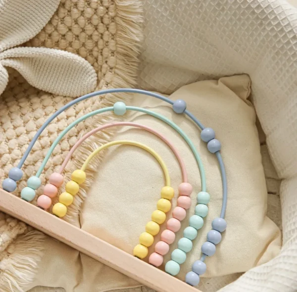 A wooden toy with beads and an abacus.