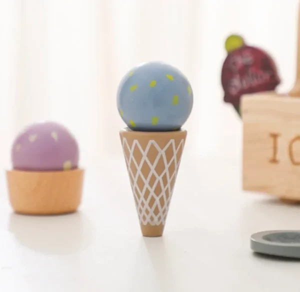 A wooden toy ice cream cone with balls inside.