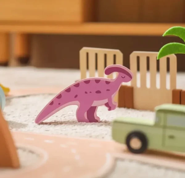 A toy dinosaur is in the foreground with other toys.