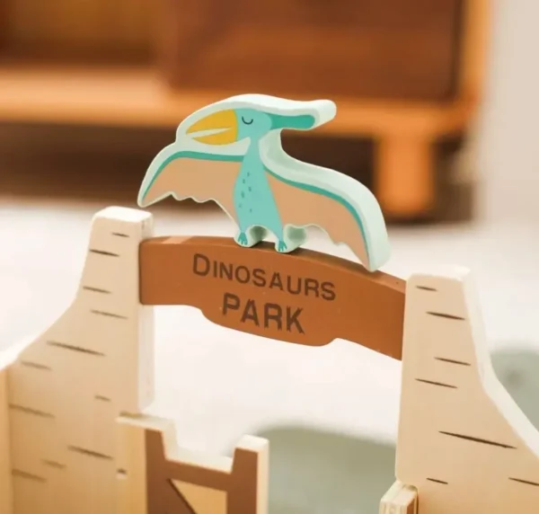 A wooden dinosaur toy sitting on top of a table.