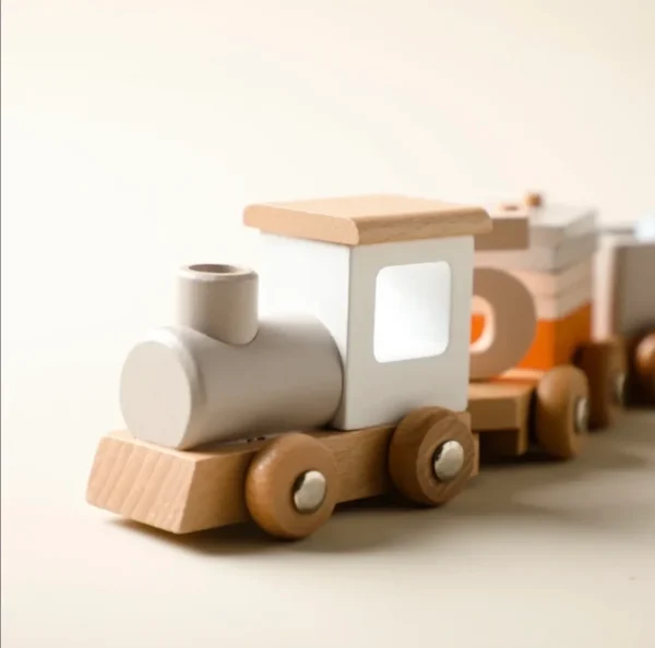 A wooden toy train with white and orange cars.