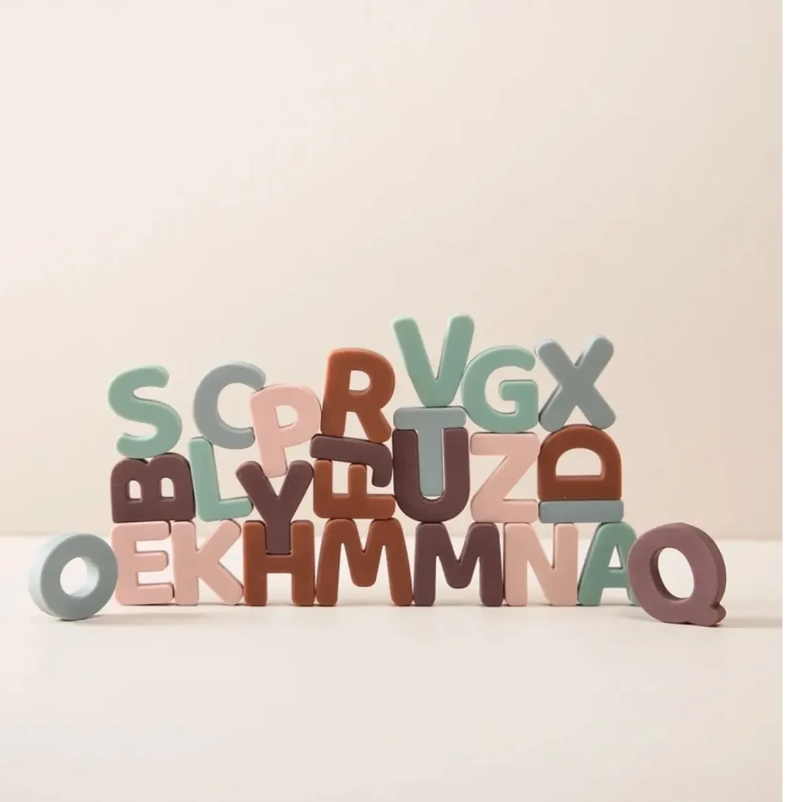 A pile of wooden letters sitting on top of each other.