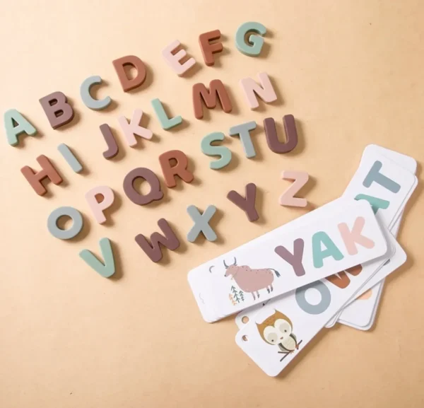 A table with wooden letters and cards on it.