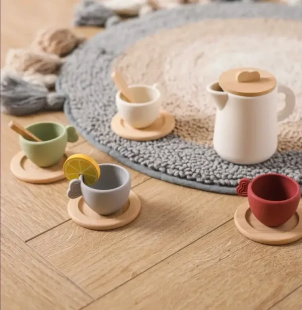 A wooden tea set with cups and saucers.