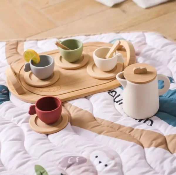 A wooden tray with cups and spoons on top of it.