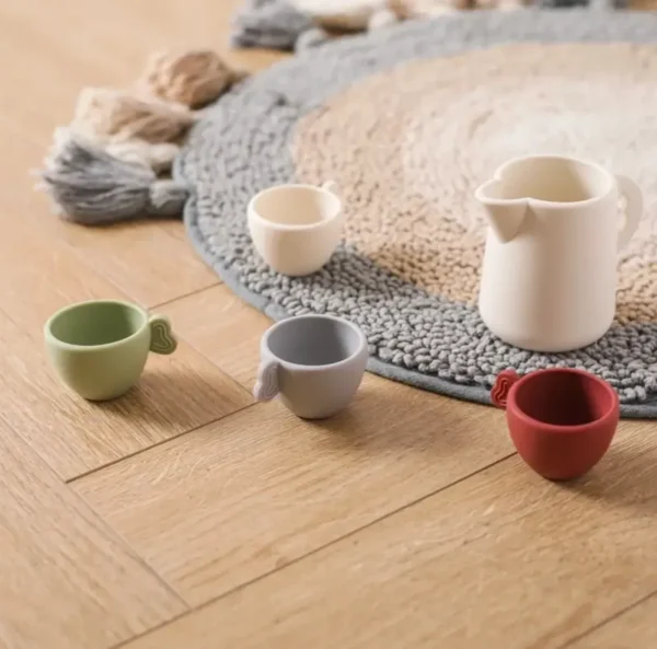 A group of cups and saucers on the floor.