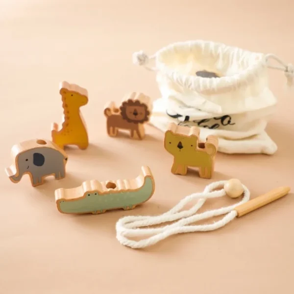 A wooden toy set of animals and rope.