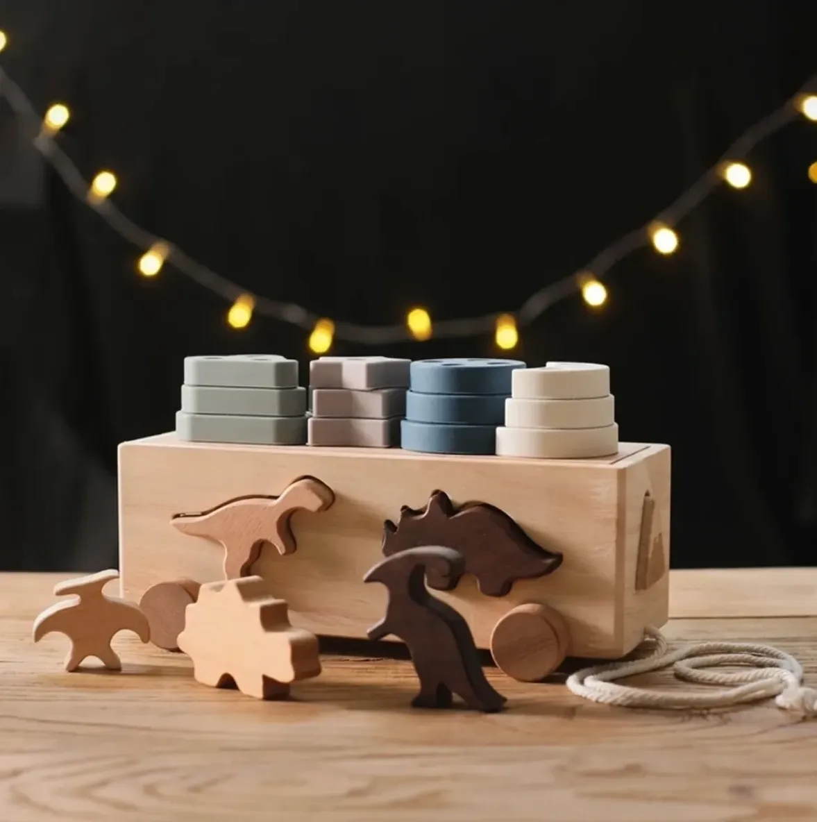 A wooden box with different shapes of animals and yarn.