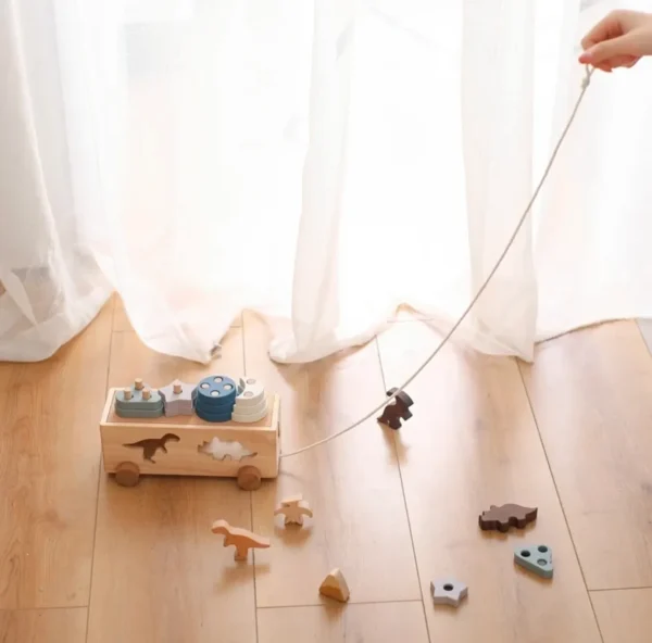 A person holding onto a string with toys on it