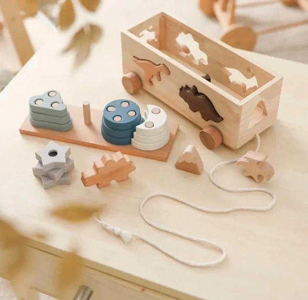 A wooden toy set with animals and shapes.