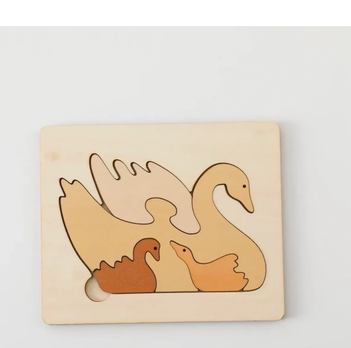 A wooden puzzle of an animal and its babies.