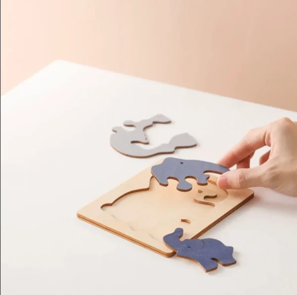 A person is playing with wooden puzzle pieces