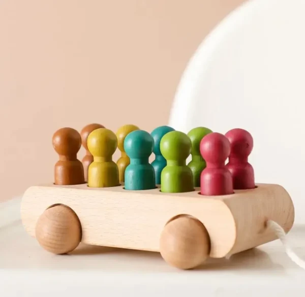 A wooden toy car with people on it.